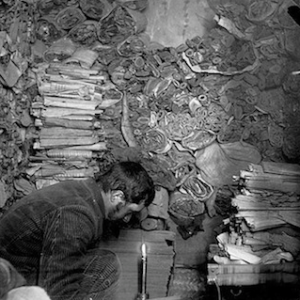 Paul Pelliot working in the library cave at Dunhuang in 1908