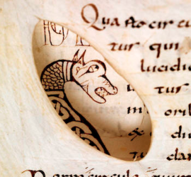 "Through-view" of an animal head initial. Eastern France, the first third of the ninth century (Bamberg, Staatsbibliothek, Msc.Nat. MS 1, fol. 25v and 26v).