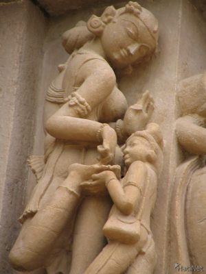 Sculpture of a woman removing a thorn from her foot, northwest side exterior wall, Lakshmana temple.