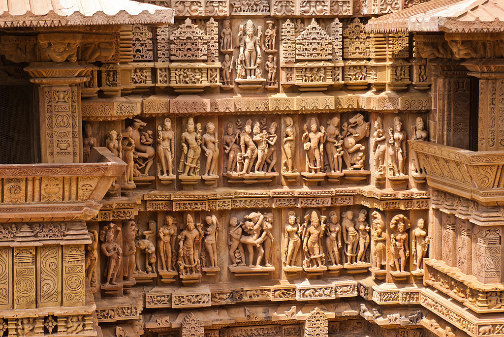Figural groupings on the temple exterior including Shiva, mithuna, and erotic couples, Lakshmana temple