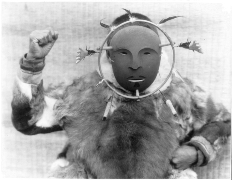 Edward S. Curtis, A man wearing a ceremonial mask of the Nunivak style, c. 1929, photograph (Edward S. Curtis Collection, Library of Congress)
