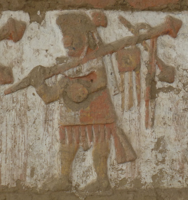 Adobe mural depicting victorious warrior with captured weapons and clothing, Huaca de la Luna, Peru