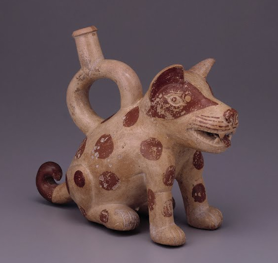Sculptural ceramic ceremonial vessel that represents a dog, c. 100-800 C.E., Moche, Peru, 180 mm high (Museo Larco). This spotted dog is represented in several scenes of Moche art accompanying Ai Apaec, the Moche mythological hero.