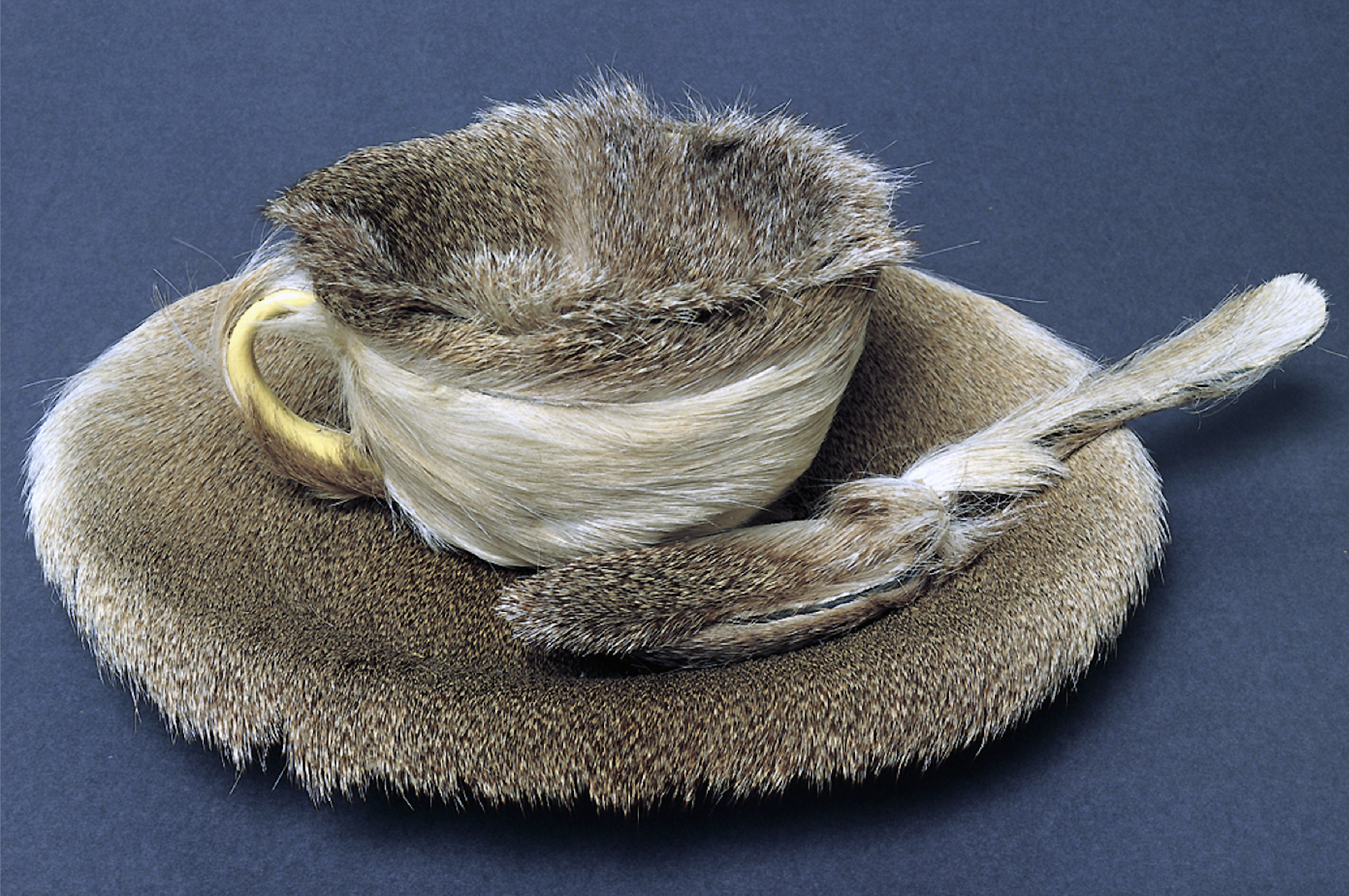 Meret Oppenheim. Object, 1936. Fur-covered cup, saucer, and spoon, cup 4-3/8 inches in diameter; saucer 9-3/8 inches in diameter; spoon 8 inches long, overall height 2-7/8" (The Museum of Modern Art)