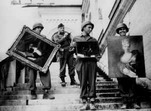 Monuments, Fine Arts, and Archives (MFAA) Officer James Rorimer supervises U.S. soldiers recovering looted paintings from Neuschwanstein Castle in Germany during World War II, April-May, 1945