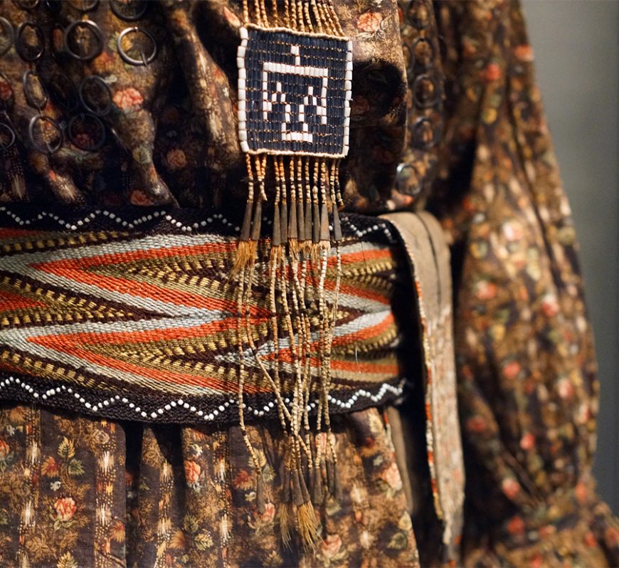 Anishinaabe outfit (detail), c. 1790, collected by Lieutenant Andrew Foster, Fort Michilimackinac (British), Michigan, Birchbark, cotton, linen, wool, feathers, silk, silver brooches, porcupine quills, horsehair, hide, sinew; the moccasins were likely made by the Huron–Wendat people (National Museum of the American Indian, Smithsonian Institution)