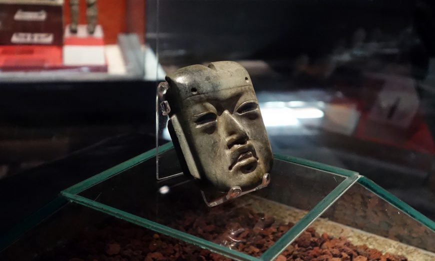 Olmec-style mask, c. 1200–400 B.C.E., found in offering 20 buried c. 1470 C.E. at the Mexica Templo Mayor, jadeite, 4 x 3-3/8 x 1-1/4 inches (Museo del Templo Mayor, Mexico City; photo: Steven Zucker, CC BY-NC-SA 2.0)