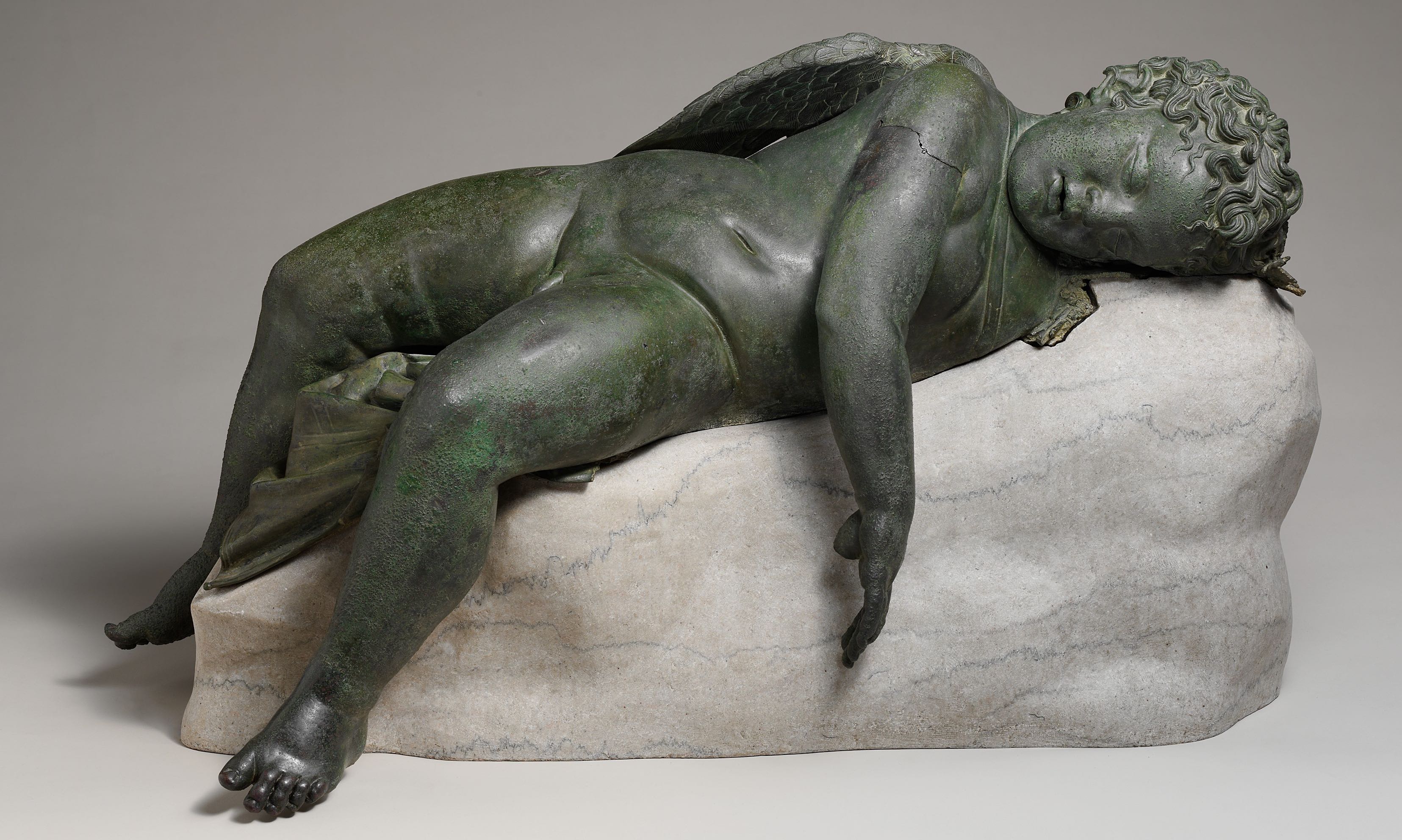 Bronze statue of Eros sleeping, 3rd–2nd century B.C.E., bronze, 16 1/2 × 14 × 33 9/16″ / 41.9 × 35.6 × 85.2 cm (The Metropolitan Museum of Art).