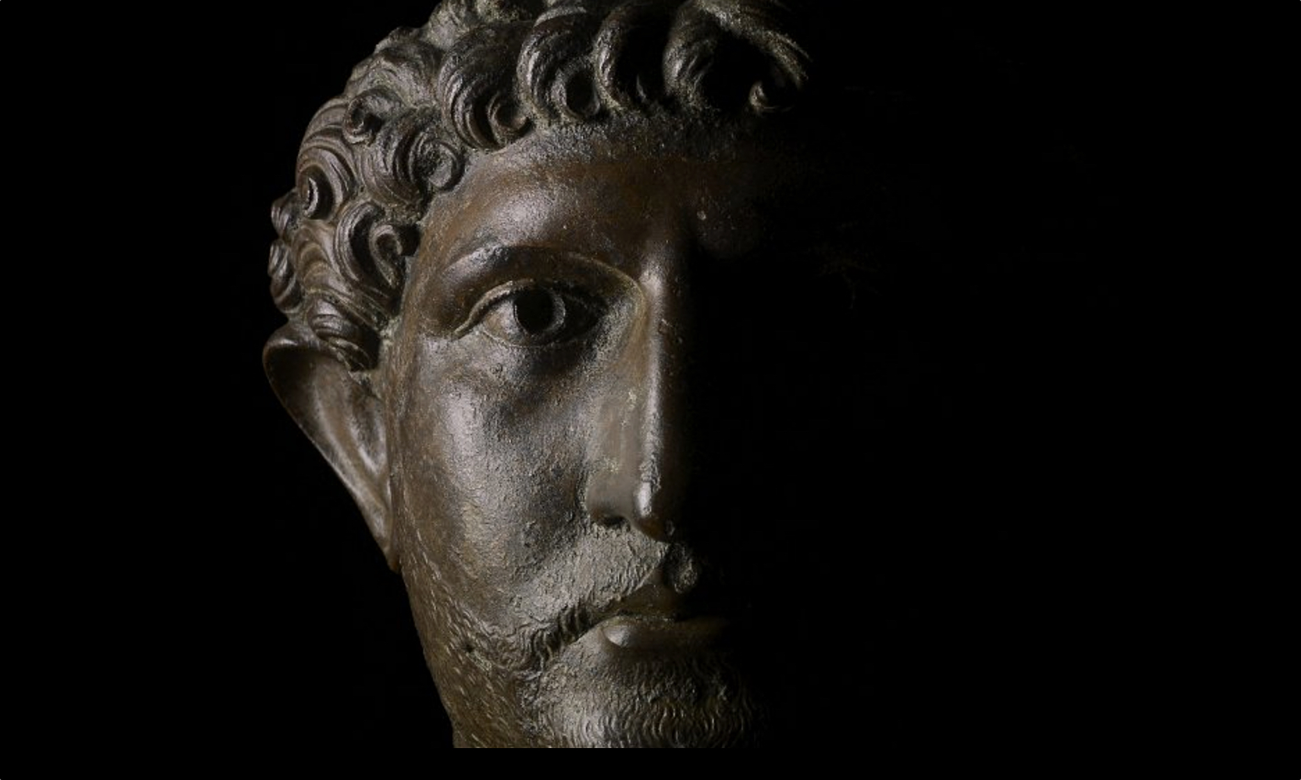 Bronze head from a statue of the Emperor Hadrian, 2nd century C.E., bronze, 43 cm high, Roman Britain © Trustees of the British Museum Hadrian (reigned 117-138 C.E.), once a tribune (staff officer) in three different legions of the Roman army and commander of a legion in one of Trajan’s wars, was often shown in military uniform. He was clearly keen to project the image of an ever-ready soldier, but other conclusions have been drawn from his surviving statues.