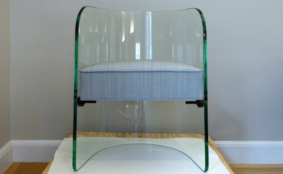 Chair, c. 1948, attributed to Henry Turchin, design direction by Louis Dierra, manufactured by the Pittsburgh Plate Glass Company (Pittsburgh, Pennsylvania, USA), slumped plate glass, metal, woven textile (Cooper Hewitt, Smithsonian Design Museum, New York City)