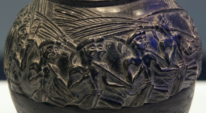 Harvester Vase from Hagia Triada, c. 1550-1500 B.C.E., black steatite, diameter 4.5 inches (Archaeological Museum of Heraklion, photo: Zde, CC BY-SA 4.0)