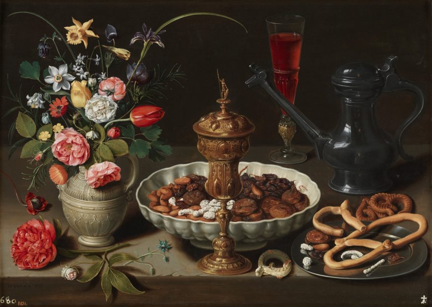 Clara Peeters, Still Life with flowers, a silver-gilt goblet, almonds, dried fruit, sweetmeats, bread sticks, wine and a pewter pitcher, 1611, oil on panel, 52 x 73 cm (Museo del Prado, Madrid)