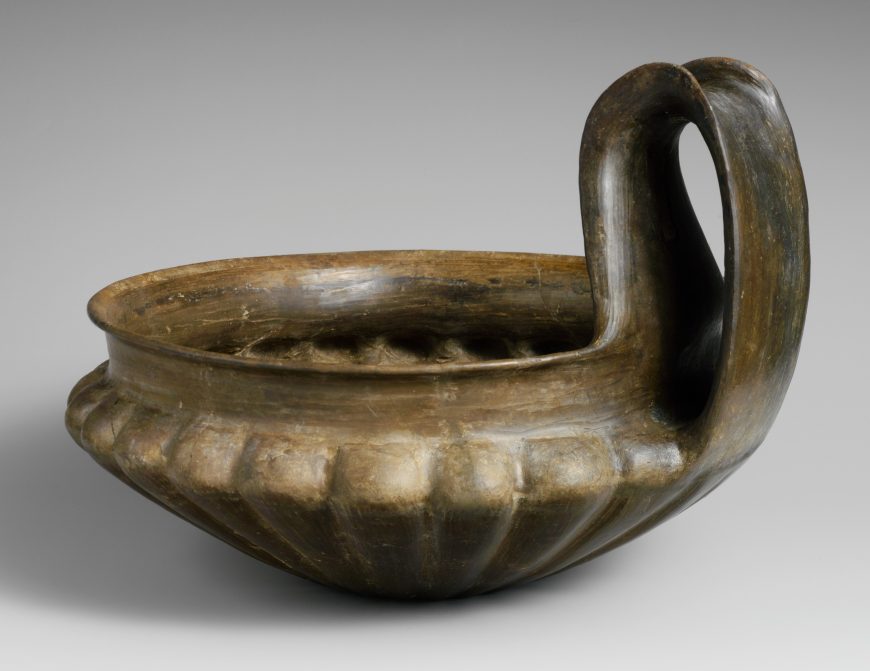 Terracotta kyathos (single-handled cup), 7th century BCE, Late Villanova, terracotta, buccheroid impasto, 4 9/16 in high without handle, 8 11/16 in with handle, 11 in diameter of mouth (The Metropolitan Museum of Art)