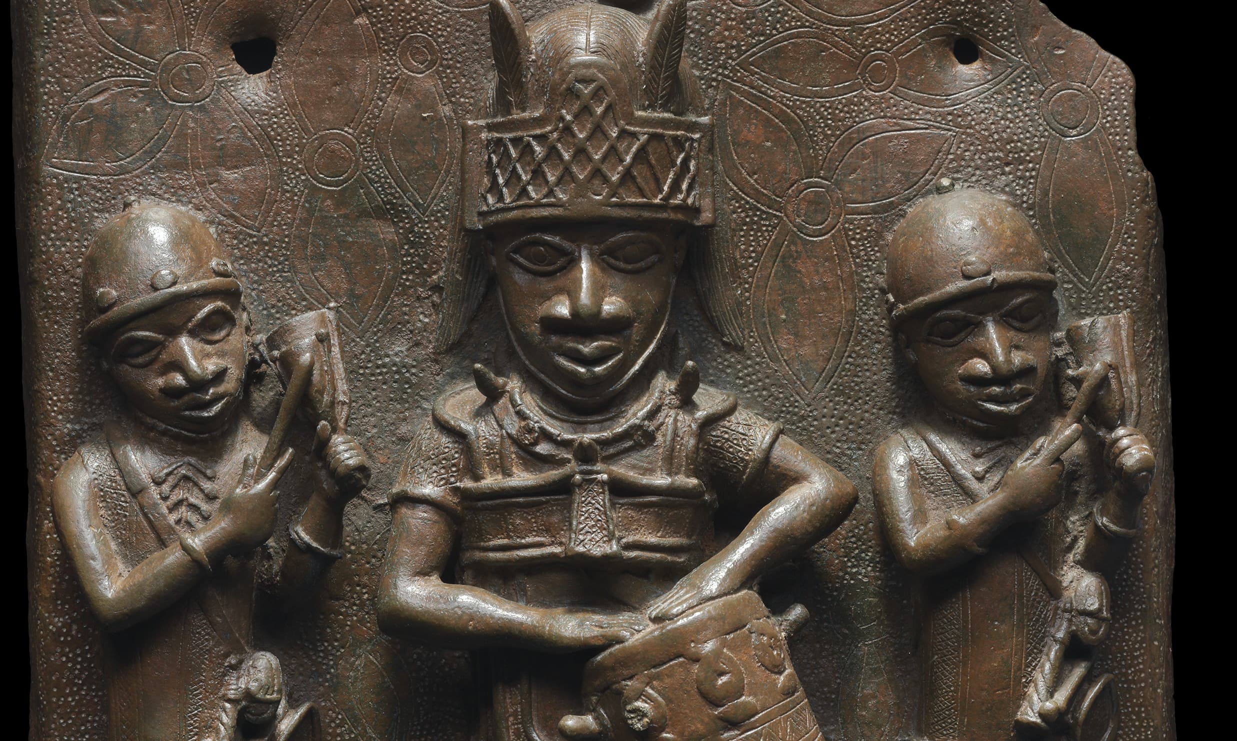 Artist Unidentified, Relief plaque showing a dignitary with drum and two attendants striking gongs, c. 1530-1570, copper alloy (Robert Owen Lehman Collection, Courtesy Museum of Fine Arts, Boston)