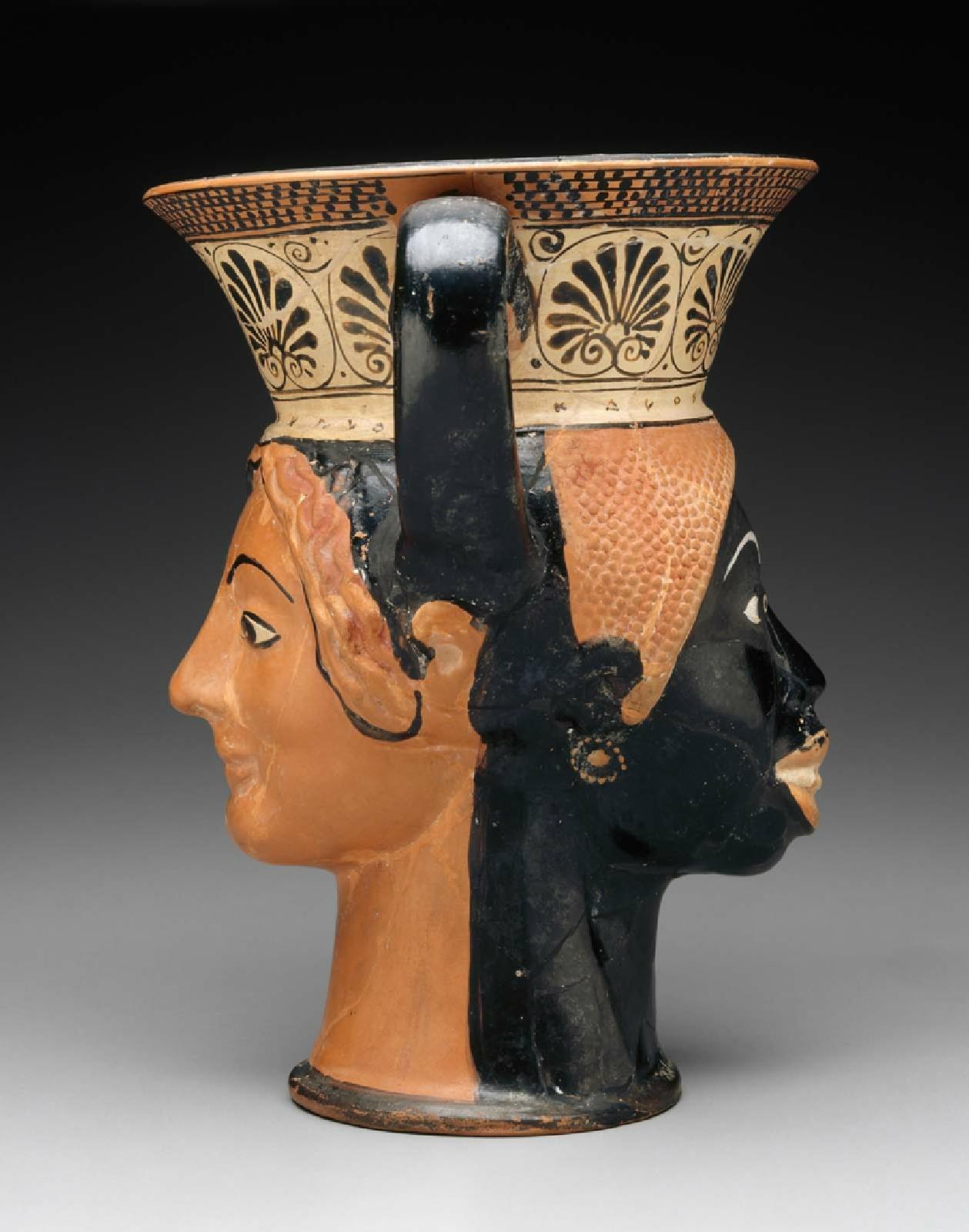 High-Handled Drinking Cup (Kantharos) in the Form of Two Heads, about 510–480 B.C.E., the London Class. Terracotta, 7 9/16 inches high (Museum of Fine Arts, Boston, Henry Lillie Pierce Fund)