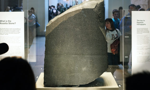 The Rosetta Stone, 196 B.C.E., Ptolemaic Period, 112.3 x 75.7 x 28.4 cm, Egypt © Trustees of the British Museum. Part of grey and pink granodiorite stela bearing priestly decree concerning Ptolemy V in three blocks of text: Hieroglyphic (14 lines), Demotic (32 lines) and Greek (53 lines).