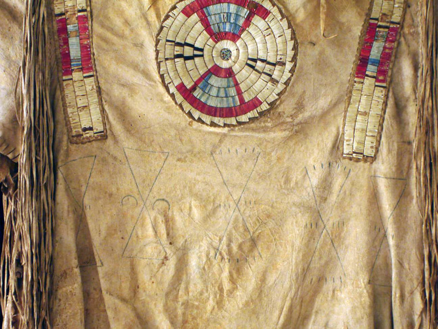 Detail of quilled war shirt (front), c. 1800-1820. Native tanned hide, porcupine quills, red trade cloth, dyes, and sinew. 34 x 43 in. (Denver Art Museum)