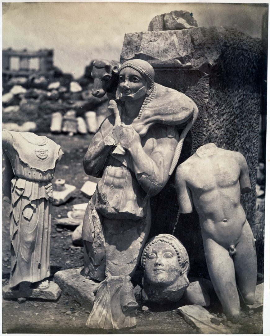When Persians sacked Athens, they destroyed or damaged many sculptures, including the now-famous Calf-Bearer (today in the Acropolis Museum). Athenians buried many of these sculptures in a pit, which were not uncovered until the 19th century. Unknown photographer, The Calf-Bearer and the Kritios Boy Shortly After Exhumation on the Acropolis, 1865, albumen silver print from glass negative, 27.7 x 21.8 cm (The Metropolitan Museum of Art, New York)