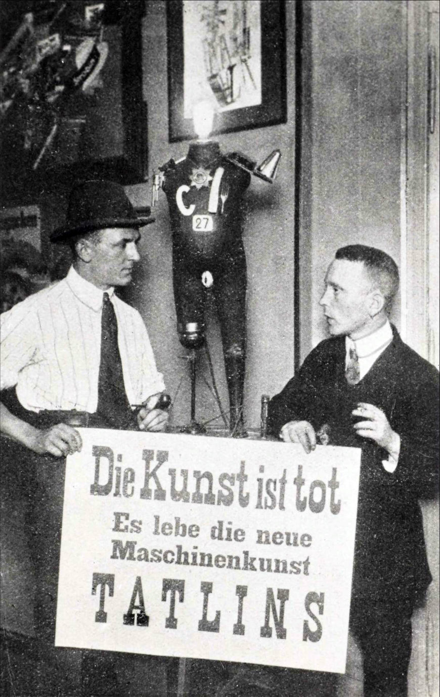 George Grosz and John Heartfield, photo at the First International Dada Fair in Berlin, 1920 in front of their sculpture Der wildgewordene Spiesser Heartfield (Elektro-Mechan. Tatlin-Plastik), 1920