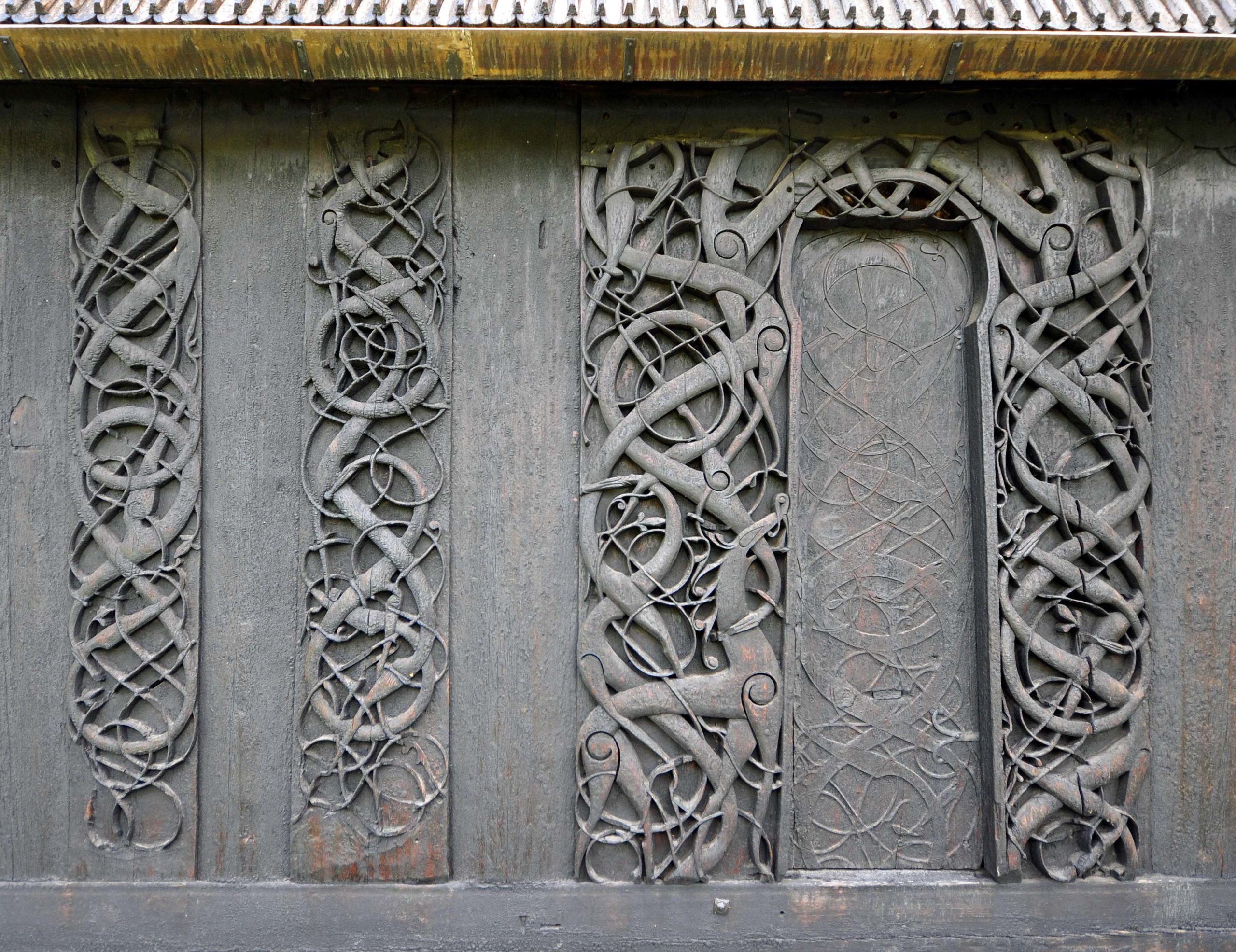 Ornaments of ancient vikings on a wooden surface. External wooden