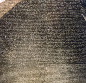 The Rosetta Stone, 196 B.C.E., Ptolemaic Period, 112.3 x 75.7 x 28.4 cm, Egypt (British Museum, London) (photo: Steven Zucker, CC BY-NC-SA 2.0). Part of grey and pink granodiorite stela bearing priestly decree concerning Ptolemy V in three blocks of text: Hieroglyphic (14 lines), Demotic (32 lines) and Greek (53 lines).