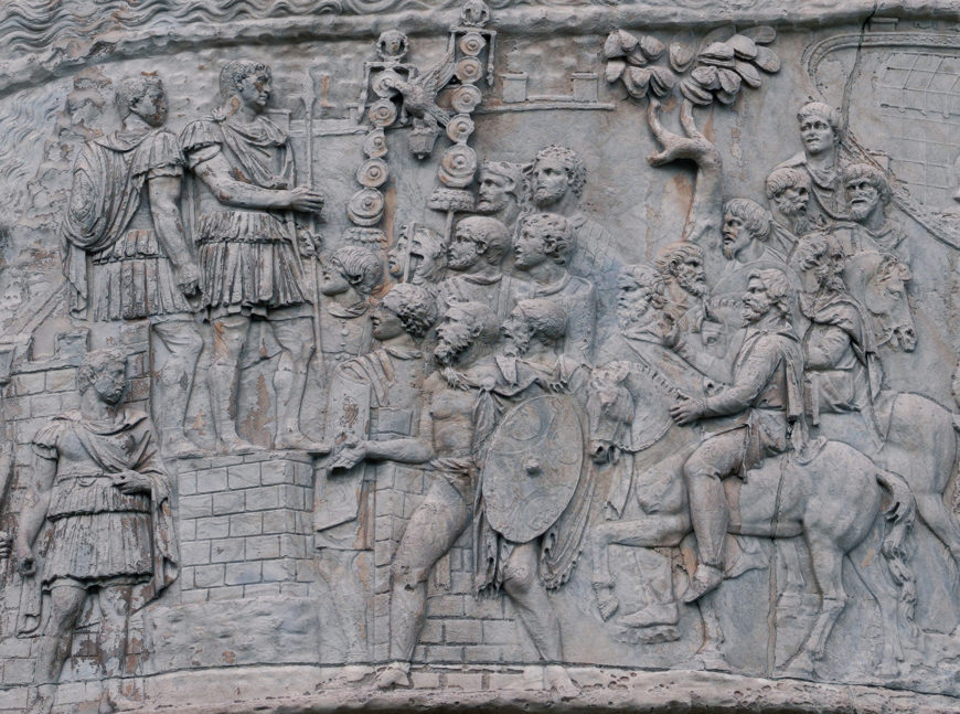 Trajan addresses troops holding spear (detail), Column of Trajan, dedicated 113 C.E., (photo: Steven Zucker, CC BY-NC-SA 2.0)