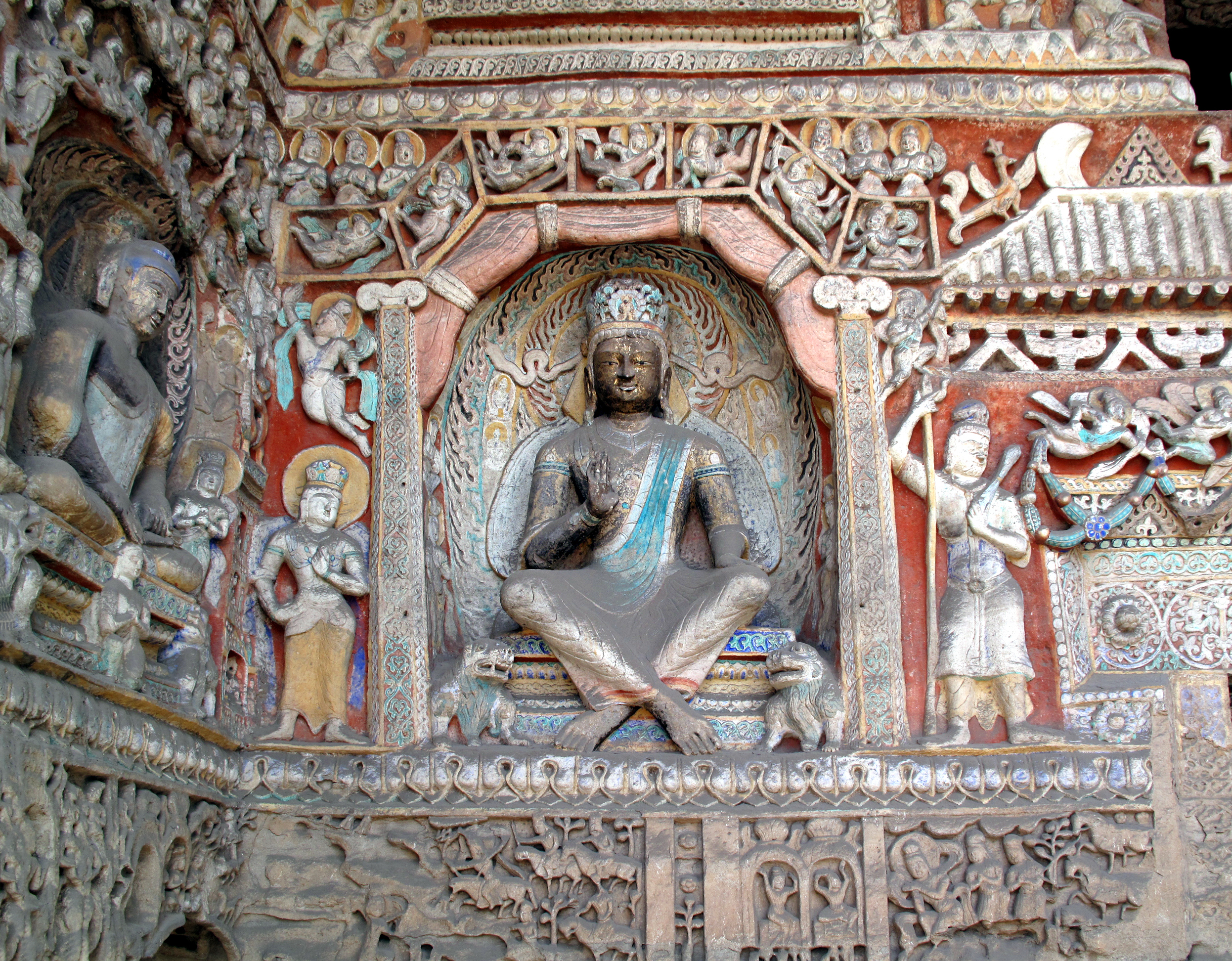 The cross-legged Bodhisattva Maitreya is shown here, on the east wall of the antechamber of Cave 9, phase II, after 650. Yungang Grottoes, Datong, China (photo: G41rn8, CC BY-SA 4.0)