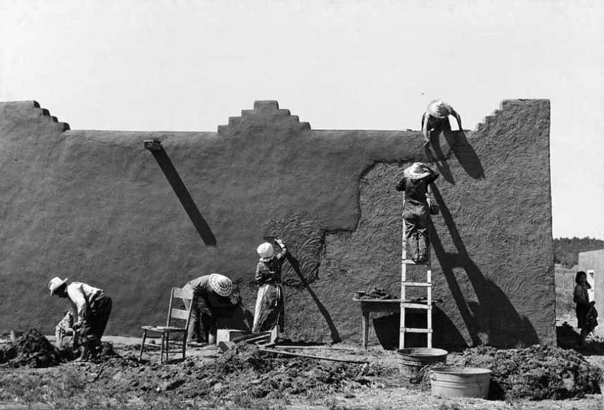 Annual replastering of an adobe structure at Chamisal, New Mexico, 1940, photo by Russel Lee