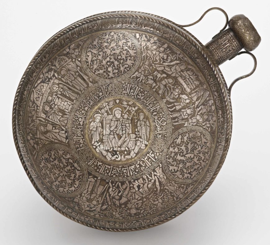 Canteen, Ayyubid period, mid-13th century, Mosul School, brass, silver inlay, Syria or Northern Iraq, 45.2 x 36.7 cm (Freer Gallery of Art, Smithsonian Institution, Washington, DC: Purchase — Charles Lang Freer Endowment, F1941.10)