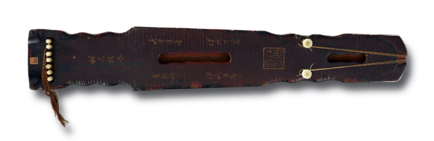 Zither (qin) inscribed with the name “Dragon’s Moan," Tang to Northern Song dynasty, 618-1127, Lacquer over wood; pegs and keys of jade; stops inlaid with metal; silk strings. Pegs, keys, and strings are replacements, China, 123.2 x 20.9 x 11.2 cm (Freer Gallery of Art, Smithsonian Institution, Washington, DC: Gift of Charles Lang Freer, F1915.100)