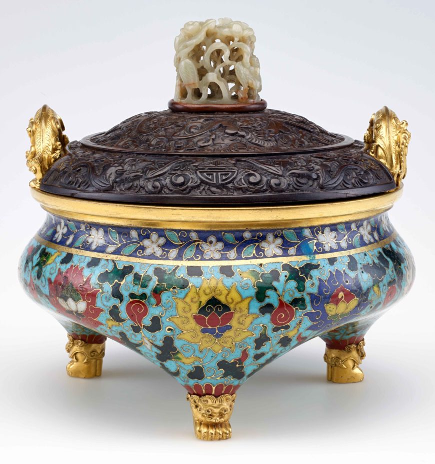 Incense burner in shape of a tripod (li) with design of lotus, Ming dynasty, Hongzhi or Zhengde reign, 15th or early 16th century; 14th century jade knob, Enamels, brass, wire (cloisonné); with later gilt metal handles, wooden cover with Yuan dynasty jade knob, China, 18.4 × 19.4 cm (Freer Gallery of Art, Smithsonian Institution, Washington, DC: Purchase — Charles Lang Freer Endowment, F1961.12a-b)