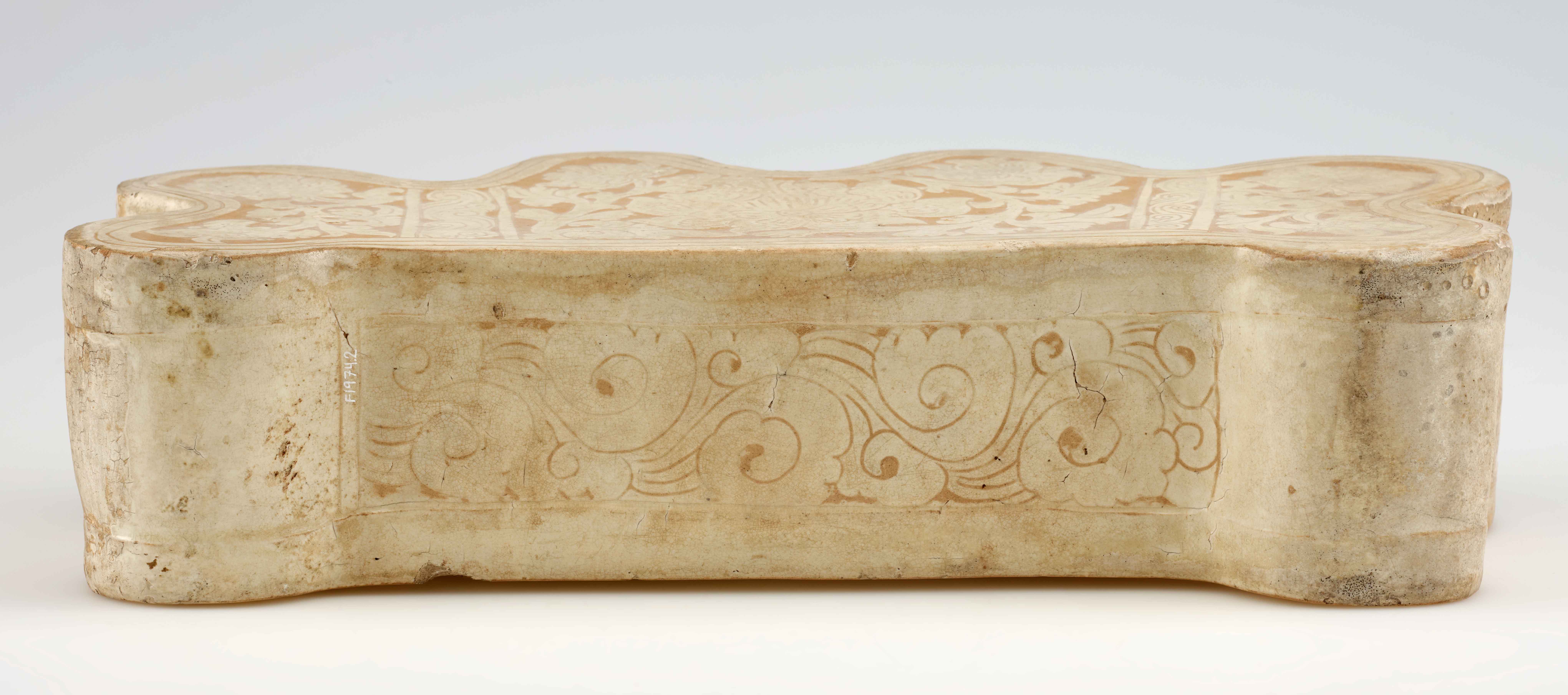 Pillow, Northern Song dynasty, 1063, Cizhou-type ware, stoneware with white slip under transparent colorless glaze, China, probably southern Shaanxi province, 19.2 x 39.8 x 10 cm (Freer Gallery of Art, Smithsonian Institution, Washington, DC: Gift of Eugene and Agnes E. Meyer, F1974.2)