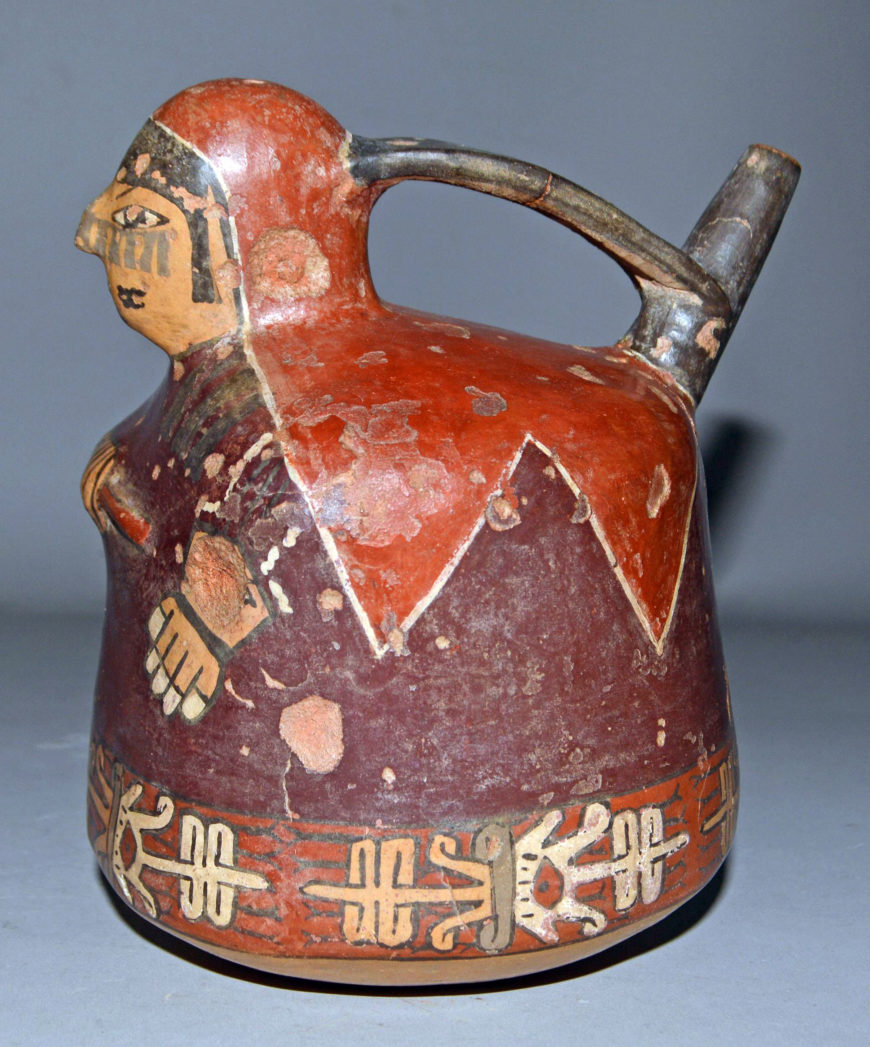 Spout and bridge vessel in the shape of a woman, 100 B.C.E.–600 C.E., Nasca, painted pottery, 16.5 x 13 cm (© Trustees of the British Museum)