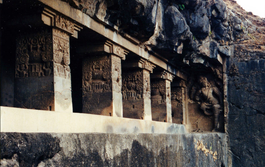 Upper-story veranda pillars with Buddha images and Shaiva guardian figure, Cave 15, c. early 8th century, Ellora (photo: Lisa Owen)