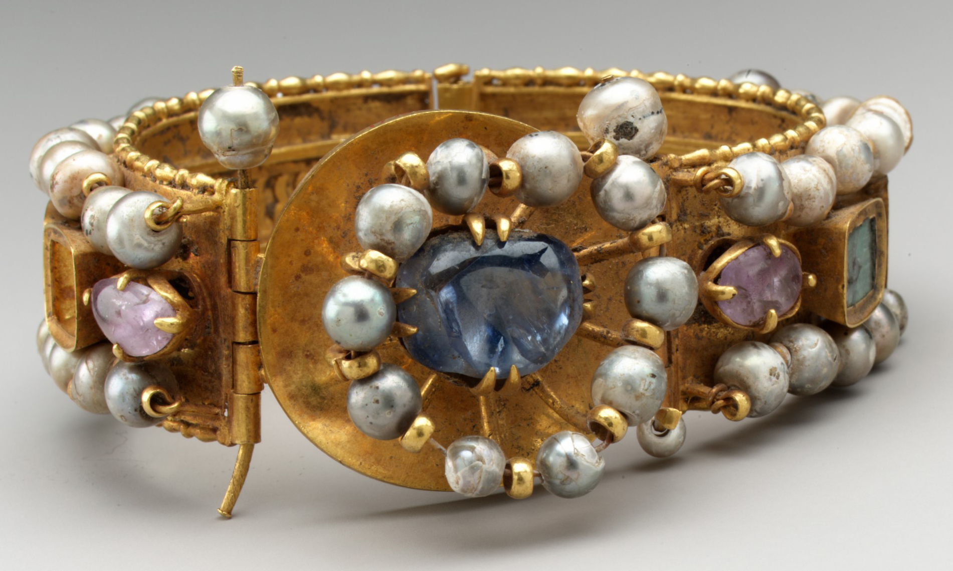 Bracelet, early Byzantine, 500–700, Constantinople (?), gold, silver, pearl, amethyst, sapphire, opal, glass, quartz, and emerald plasma, c. 4 x 8 cm (The Metropolitan Museum of Art)