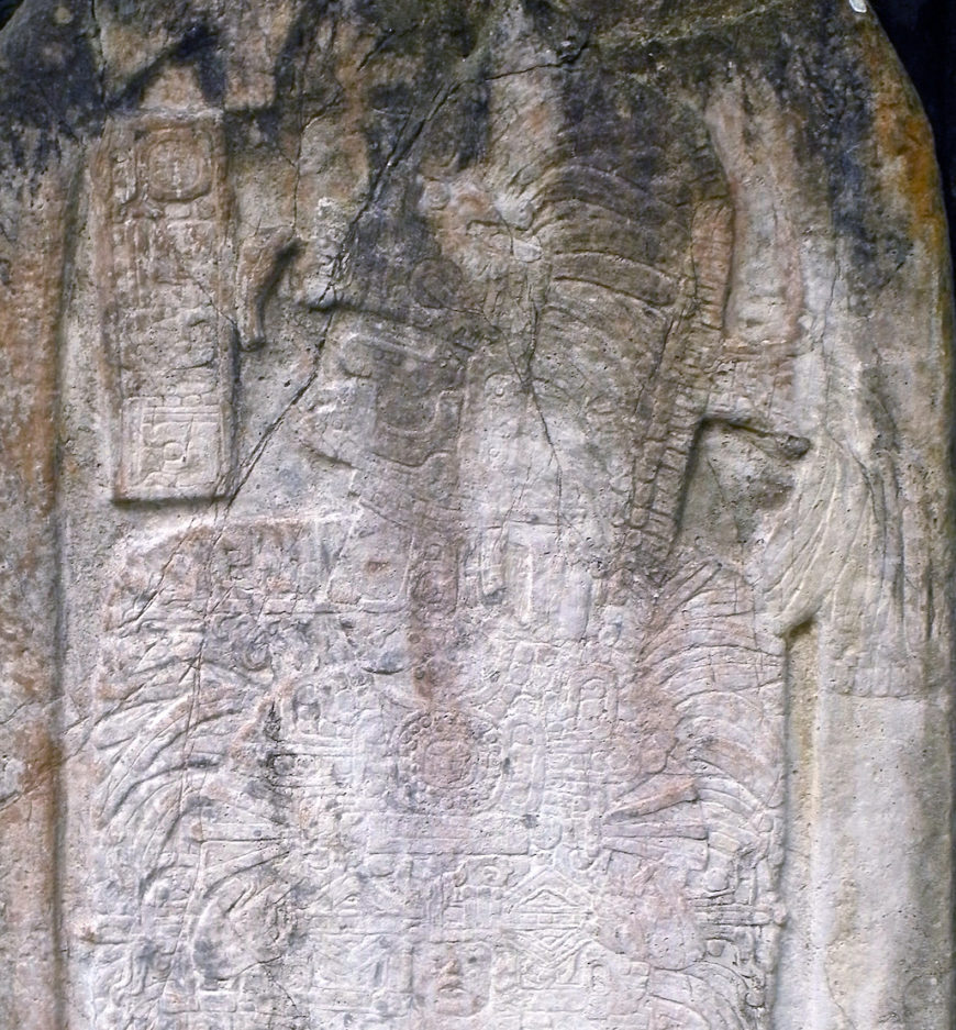 Detail of the headdress and feathered backrack in the upper portion of Stela 16, c. 711 C.E., Classic Period, from the site of Tikal, Guatemala, 3.5 x 1.28 m (photo: Luis Alveart, CC BY-NC 2.0)