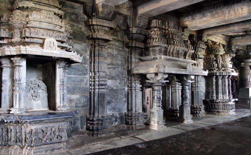 Interior of Hoysaleshvara temple, showing shrines along the western wall of the central hall. (The sculpture inside the shrine seen in the left on this photo is not original to that shrine.)