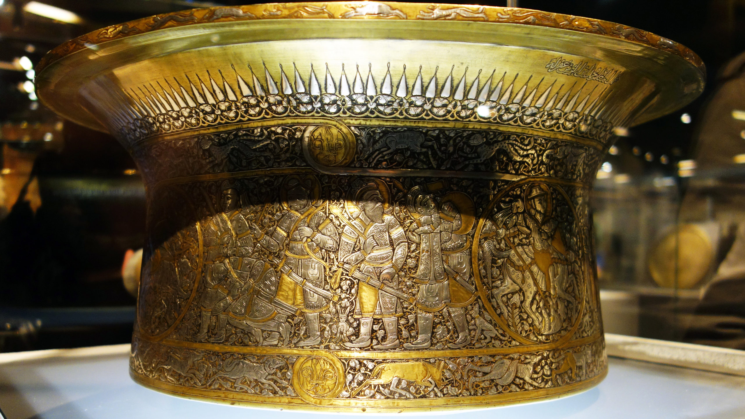 Mohammed ibn al-Zain, Basin (Baptistère de Saint Louis), c. 1320-40, brass inlaid with silver and gold, 22.2 x 50.2 cm, Egypt or Syria (Musée du Louvre)