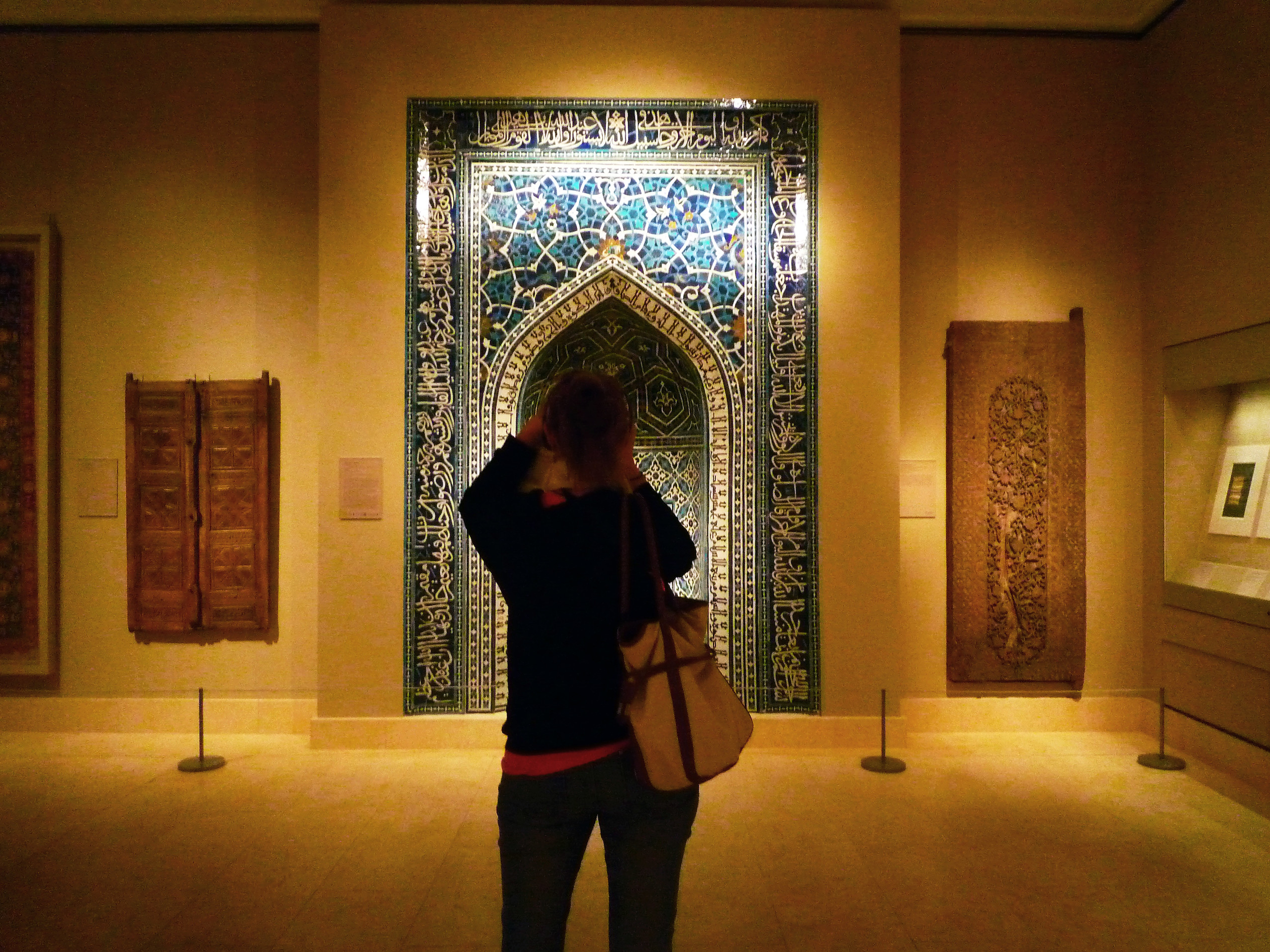 Photographer in front of Mihrab (prayer niche), 1354–55 (A.H. 755), just after the Ilkhanid period, Madrasa Imami, Isfahan, Iran, polychrome glazed tiles, 135-1/16 x 113-11/16 inches / 343.1 x 288.7 cm (Metropolitan Museum of Art, New York)