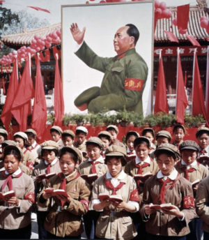 Children in front of a picture of Mao Zedong, c. 1968
