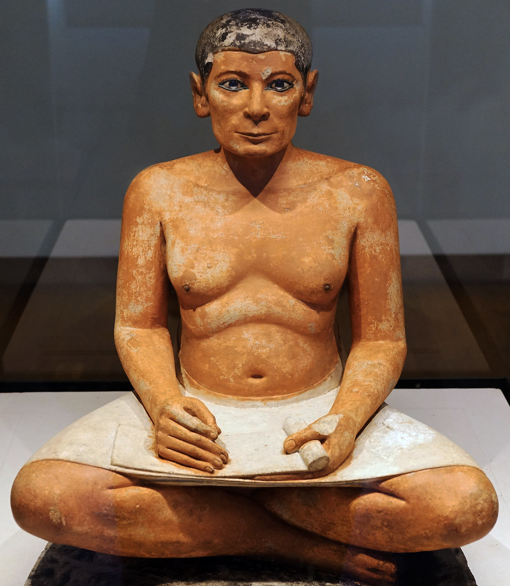 Seated Scribe​, c. 2500 B.C.E., c. 4th Dynasty, Old Kingdom, painted limestone with rock crystal, magnesite, and copper/arsenic inlay for the eyes and wood for the nipples, found in Saqqara