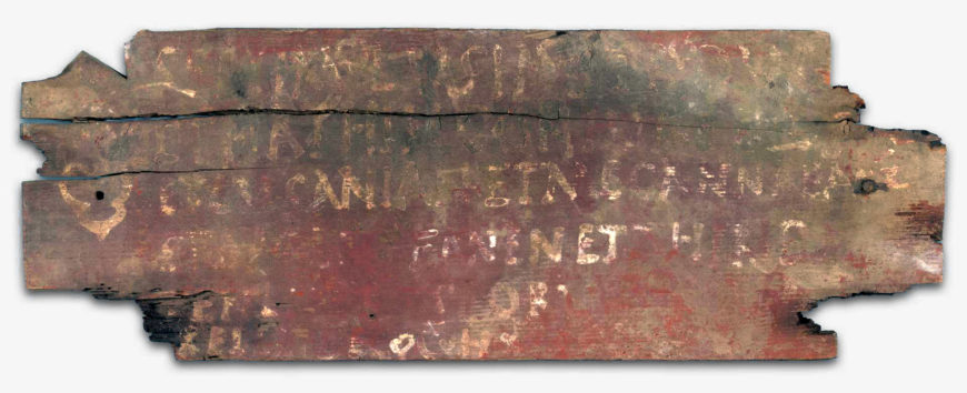Figure 11 Third century CE Latin inscription, painted on a wooden plaque, found in the Palmyrene gate, reading “To Septimius Lysias Strategos of Dura and the wife of the one mentioned above, Nathis, and their children Lysianius and Mecannaea, and Apollophanes and Thiridates, From the Beneficiarii and Decurions of the Cohort. Yale University Art Gallery, 1929.370