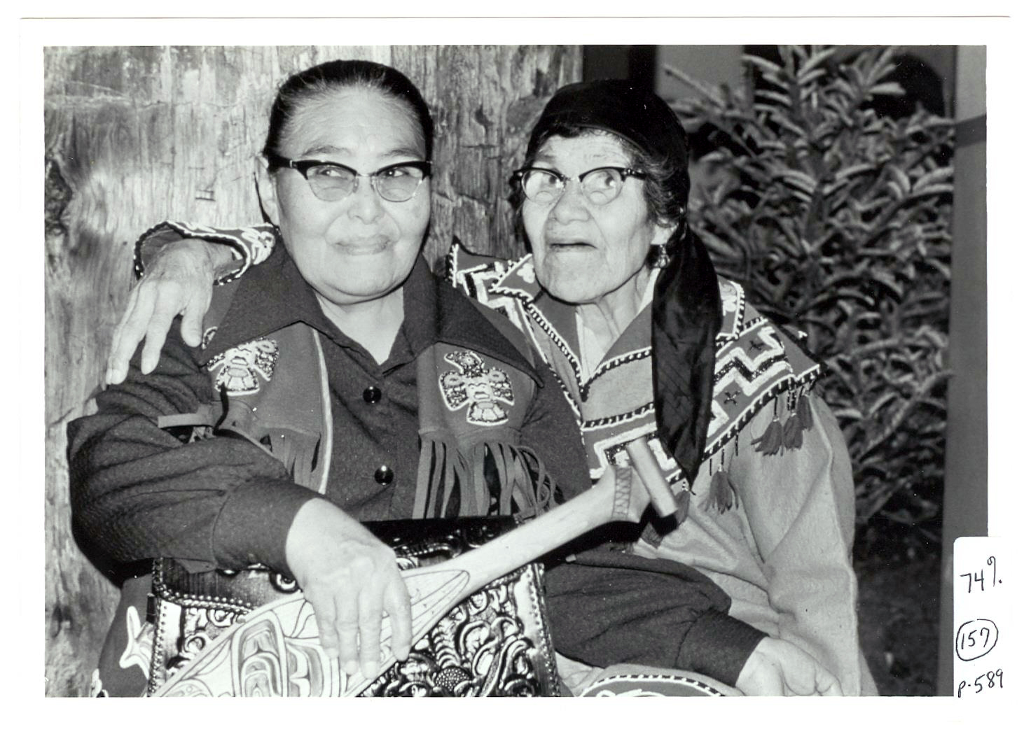Emma Marks, Seigheighei (Tlingit) and Jennie Thlunaut, Shaaxʼsáani Kéekʼ (Tlingit), April 1974. Emma Marks wears a vest beaded with the raven and sockeye salmon crests of her clan, the Lukaxh.ádi clan of the Raven moiety (the tail of the sockeye salmon can be seen at the bottom left of the image on her vest pocket). Jennie Thlunaut, a master naaxein weaver discussed in this essay, wears a beaded tunic with V-yoke in the Athabascan style that was popular among northern Tlingit communities, like Klukwan where Thlunaut grew up (Dauenhauer Photograph Collection. PO 004, Box 7, Item 6. William L. Paul Sr. Archives, Sealaska Heritage Institute, Juneau, AK)
