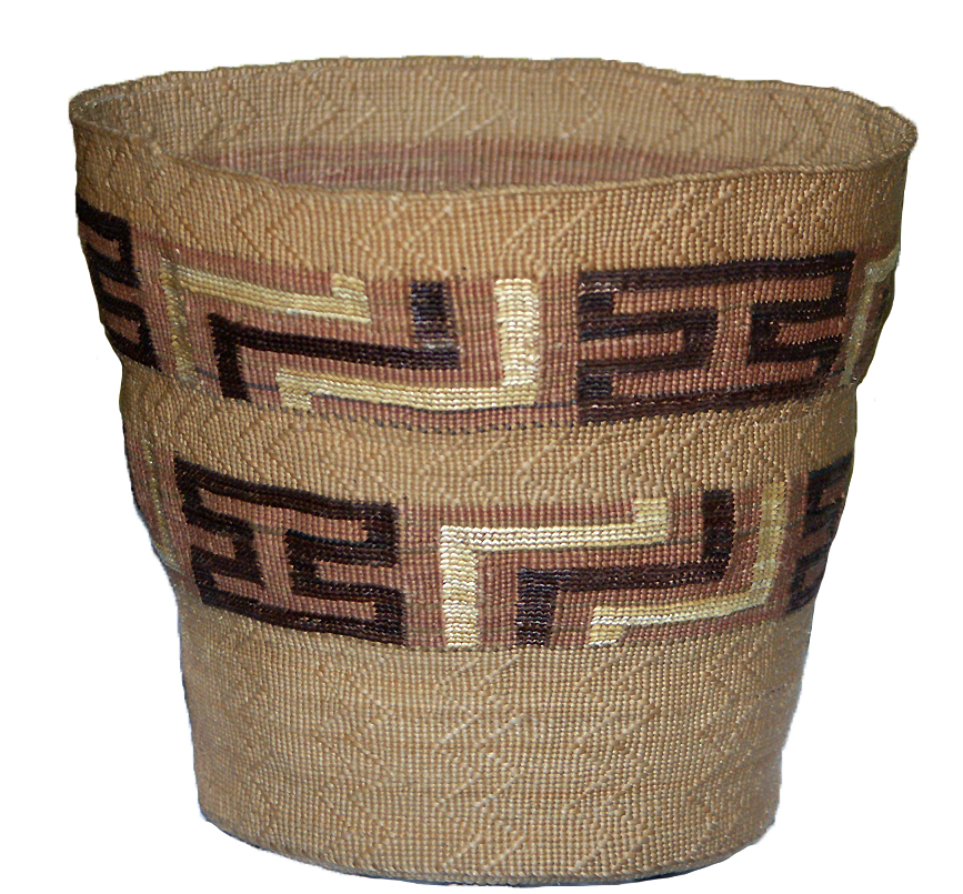 Spruce root basket by Nellie (née Williams) Aragon, Shakéiwés (Tlingit, Kooskʼeidí clan), 1932. This fine basket shows Aragonʼs use of the skip stitch pattern (visible as zig zags running vertically up the basket) and multi-colored fibers, including the shiny brown stems of maidenhair fern (visible in the capital “I” shapes known as the “tattoo pattern” in Tlingit basketry). Image courtesy of the Sitka Tribe of Alaska.