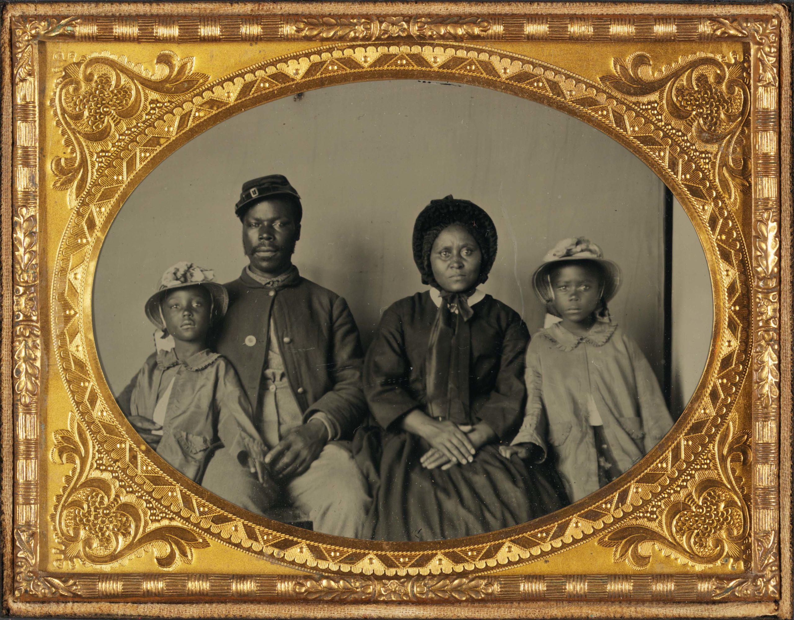 Unidentified African American soldier in U.S. Army uniform with wife and two daughters, c. 1863–65, ambrotype, 13.9 x 16.4 cm (frame), (Library of Congress)