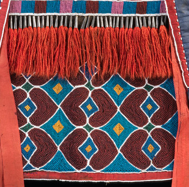 Fringe (detail), bandolier bag, Lenape (Delaware tribe, Oklahoma), c. 1850 C.E., hide, cotton cloth, silk ribbon, glass beads, wool yarn, metal cones, 68 x 47 cm (National Museum of the American Indian, New York)