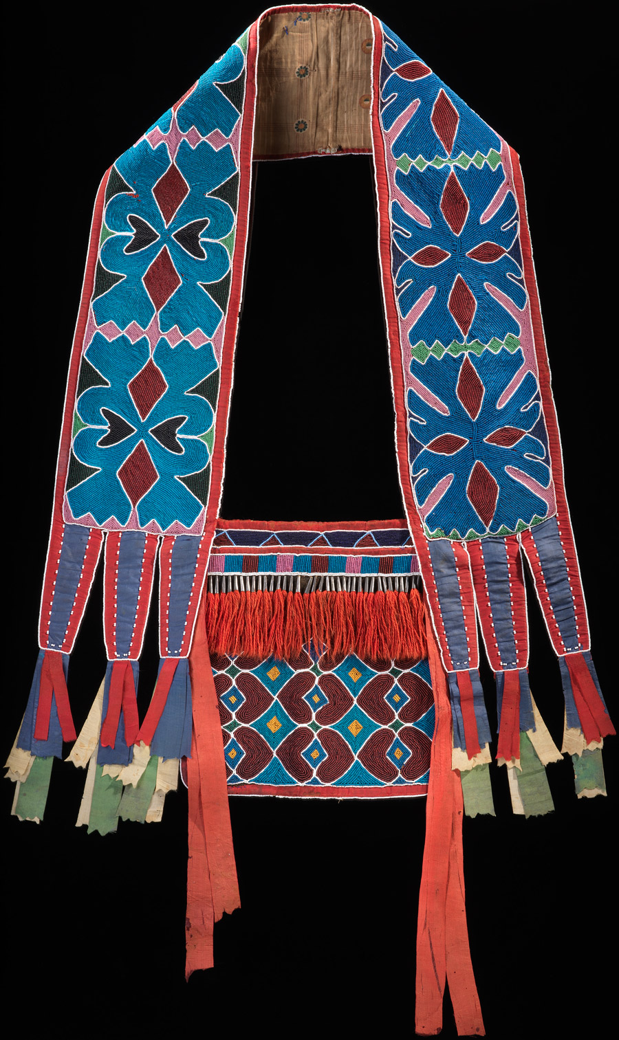 Bandolier bag, Lenape (Delaware tribe, Oklahoma), c. 1850, hide, cotton cloth, silk ribbon, glass beads, wool yarn, metal cones, 68 x 47 cm (National Museum of the American Indian, New York)