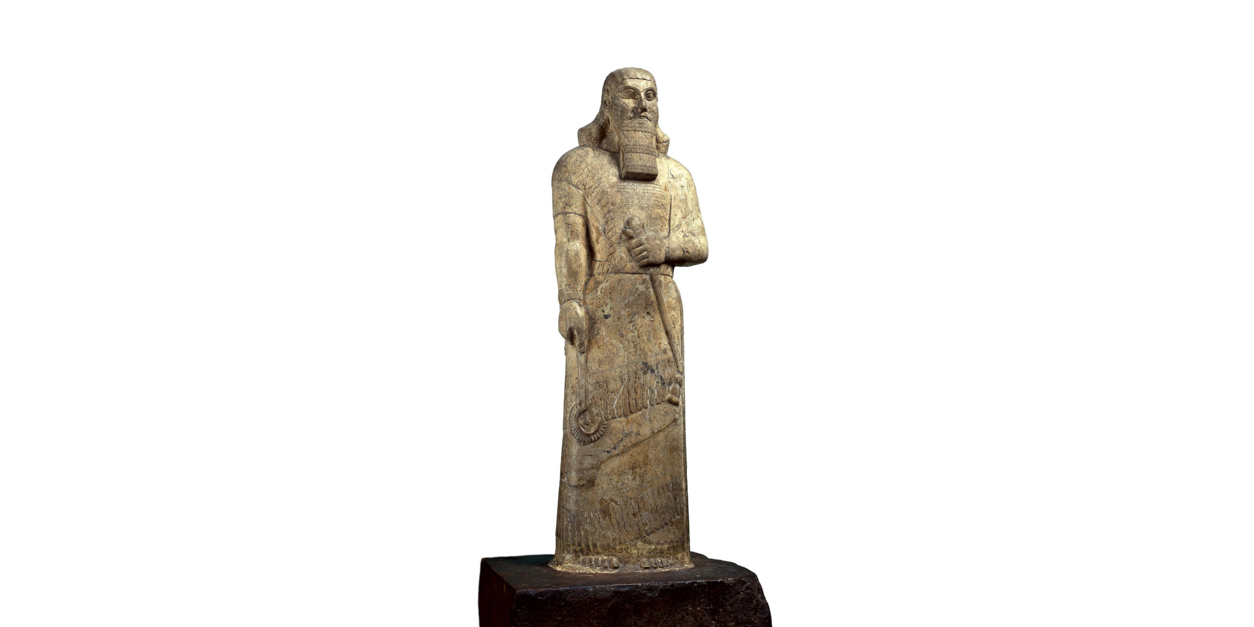Statue of Ashurnasirpal II, Neo-Assyrian, 883–859 B.C.E., from Nimrud (ancient Kalhu), northern Iraq, magnesite, 113 x 32 x 15 cm (© The Trustees of the British Museum)  This rare example of an Assyrian statue in the round was placed in the Temple of Ishtar Sharrat-niphi to remind the goddess Ishtar of the king's piety. Ashurnasirpal holds a sickle in his right hand, of a kind which gods are sometimes depicted using to fight monsters. The mace in his left hand shows his authority as vice-regent of the supreme god Ashur. The carved cuneiform inscription across his chest proclaims the king's titles and genealogy, and mentions his expedition westward to the Mediterranean Sea.