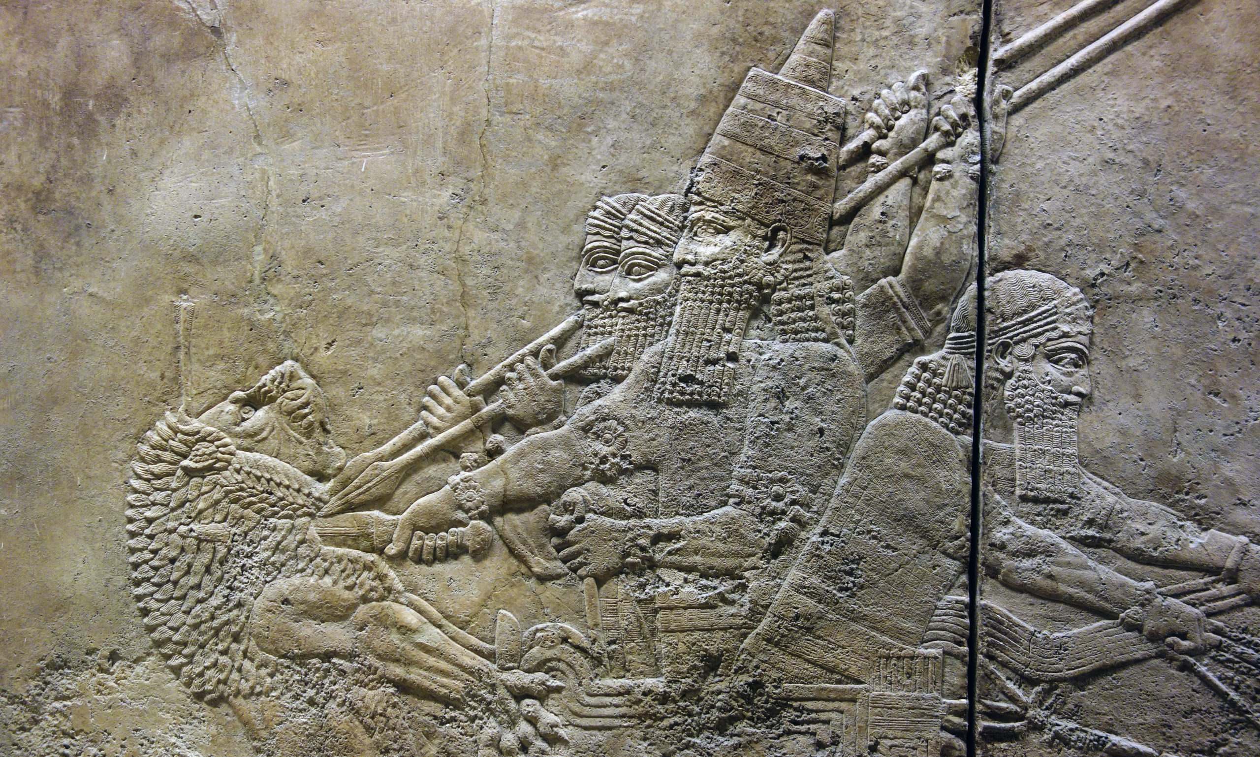 Ashurbanipal slitting the throat of a lion from his chariot (detail), Ashurbanipal Hunting Lions, gypsum hall relief from the North Palace, Ninevah, c. 645–635 B.C.E., excavated by H. Rassam beginning in 1853 (British Museum) (photo: Steven Zucker, CC BY-NC-SA 2.0)