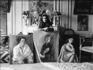 Amrita Sher-Gil with 3 paintings, 1930s, photograph (public domain)